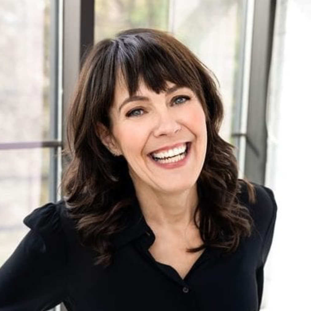 A headshot of Celia Siegel, Brand Manager. She is a woman in her 50's with should length dark hair with bangs. She smile widely while wearing a black collared button down shirt. Branding doesn't have to be boring.